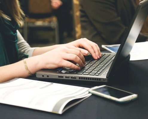 Woman typing on a laptop