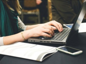 woman typing on a laptop