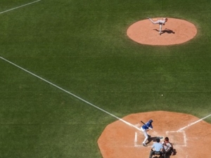 baseball field with players playing a game featured