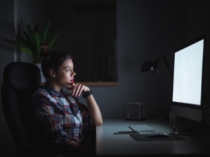 woman working late long hours featured